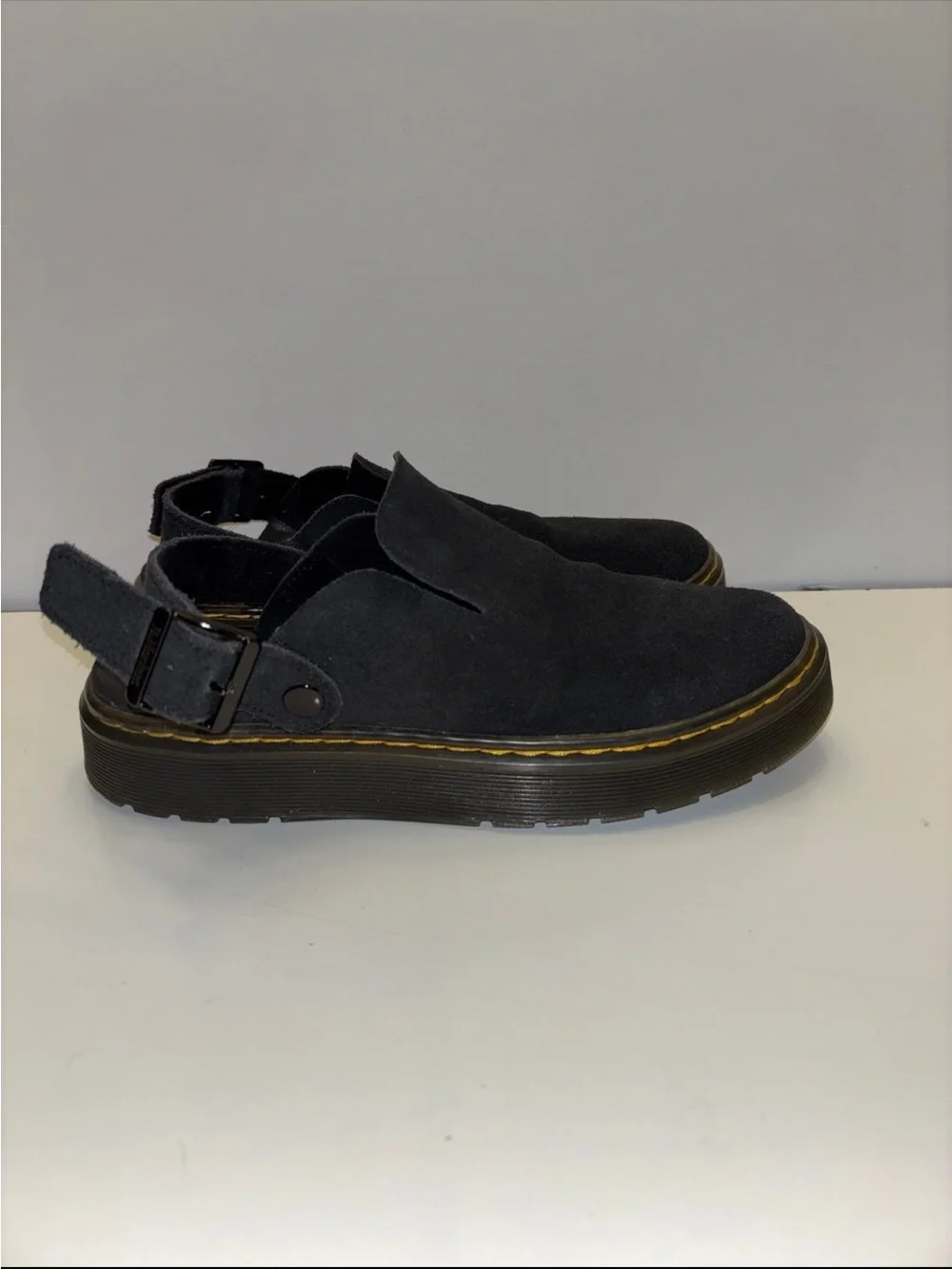 Dr. Martens Carlson slingback mules in black suede, with a chunky buckle